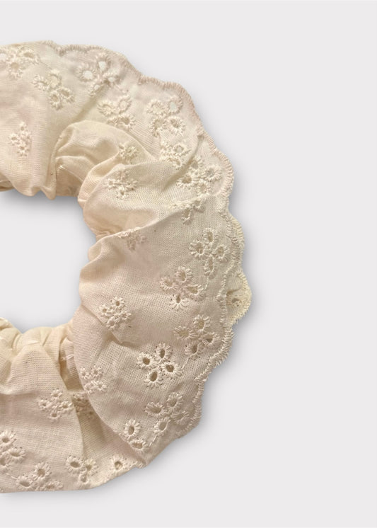 Close-up of broderie anglaise scrunchie showing lace detail and scalloped edge.