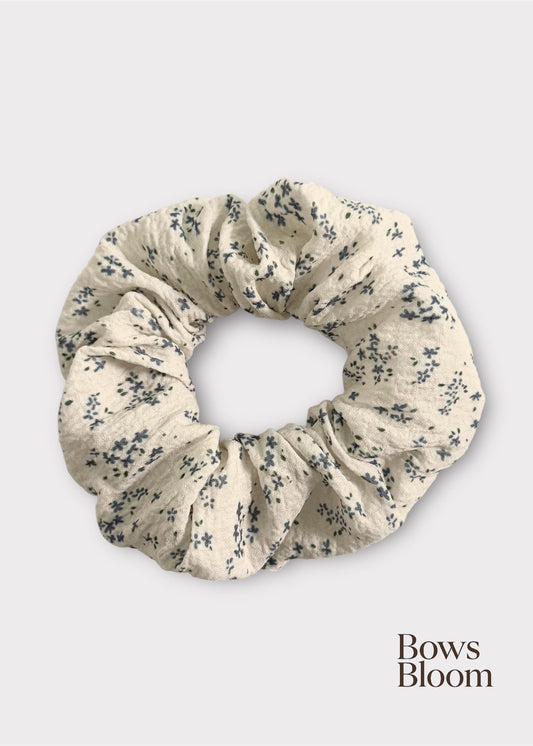 White scrunchie with tiny blue floral print, full product on light background
